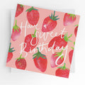 Pink square birthday greeting card with a repeat pattern of bright illustrated strawberries on a pink background and white script text reading "Have a Sweet Birthday."
