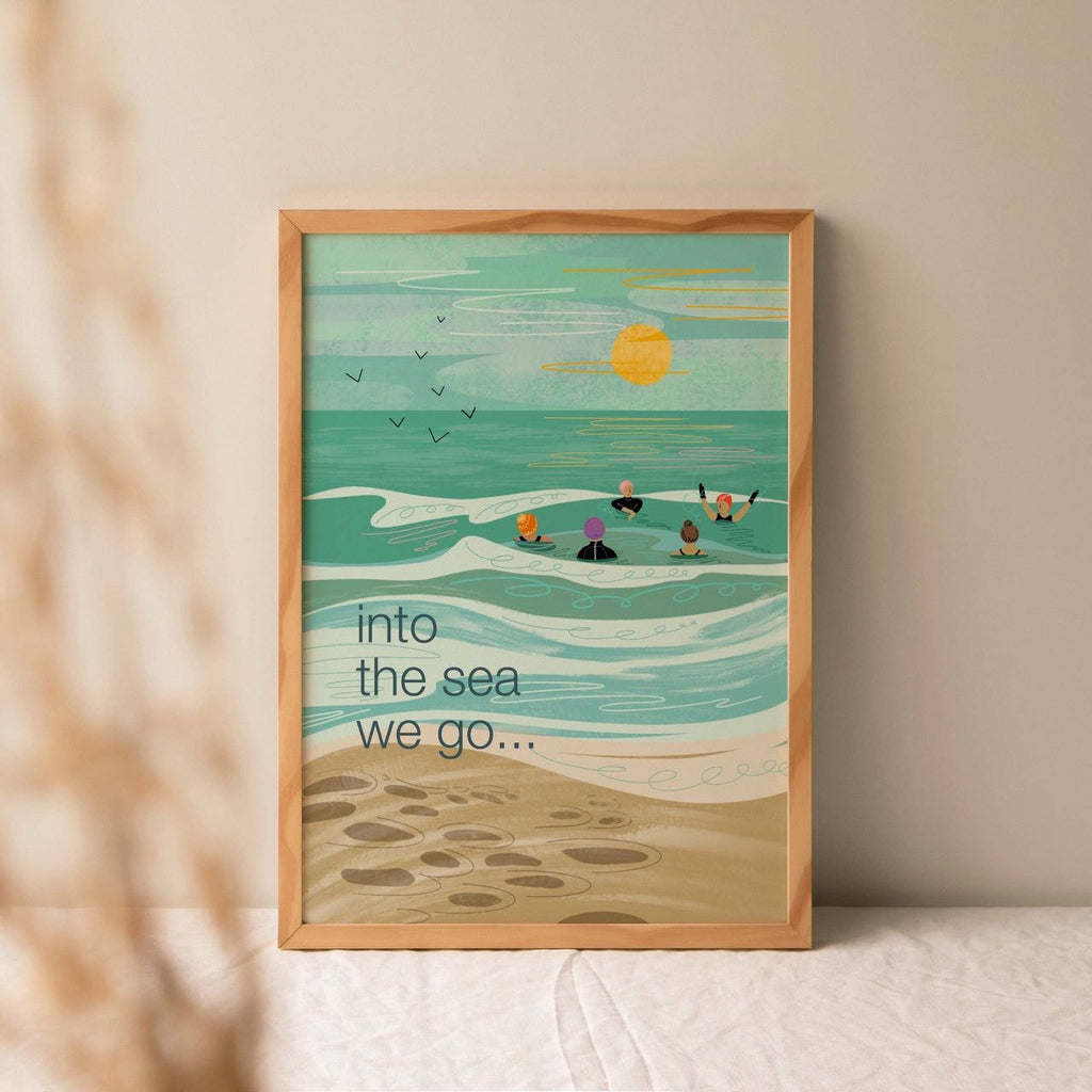 Illustrated art print showing five wild swimmers in colourful swim caps and wetsuits enjoying the sea together, with the words "into the sea we go..." in dark teal text against a teal and turquoise coastal scene with a sandy beach and golden sun.