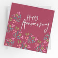  Happy Anniversary card in raspberry pink with white lettering and pink, blue and green flowers