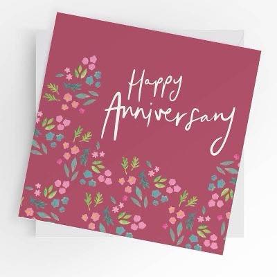  Happy Anniversary card in raspberry pink with white lettering and pink, blue and green flowers