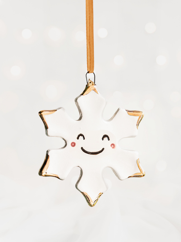 White Snowflake Ceramic Christmas Ornament with a smiley face and Gold Tips