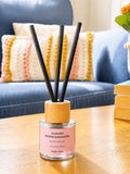 Rosy Roo luxury room reed diffuser in Black Orchid with gift tube packaging and black reeds