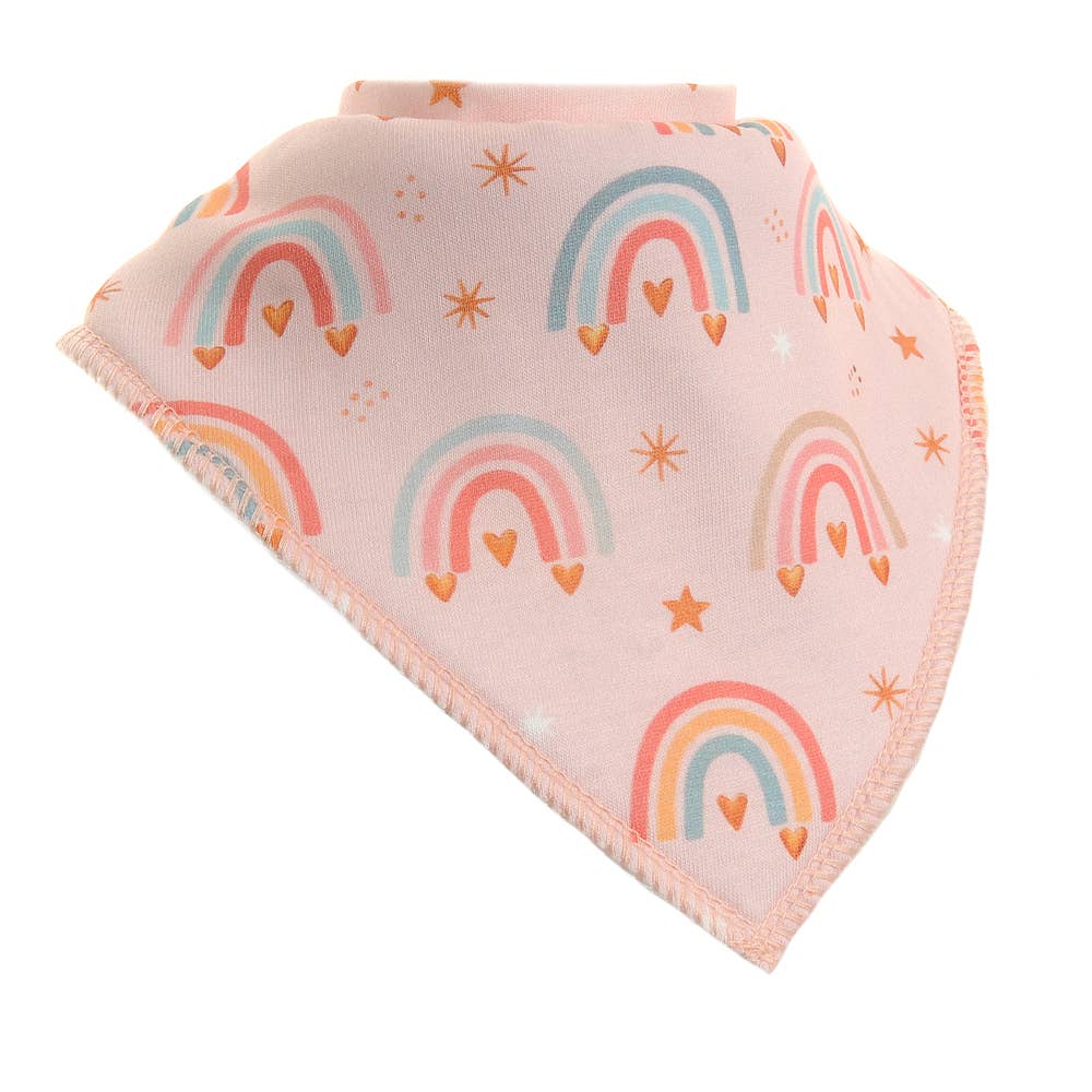 Ziggle rainbow bandana bib with a soft pink background, pastel rainbow repeat pattern in pink, peach and mint tones, scattered gold stars and orange hearts, with overlocked fringe-style edges — a sweet baby girl dribble bib and baby shower gift.
