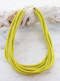 Chunky multi strand cord necklace in lime yellow with gold tone end caps and extender chain