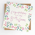 Floral wedding card reading Congratulations to the new Bride and Groom in pink lettering with kraft envelope
