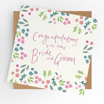 Floral wedding card reading Congratulations to the new Bride and Groom in pink lettering with kraft envelope