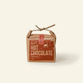 Harth Cinnamon Hot Chocolate 400g in brown paper packaging tied with string among autumn branches