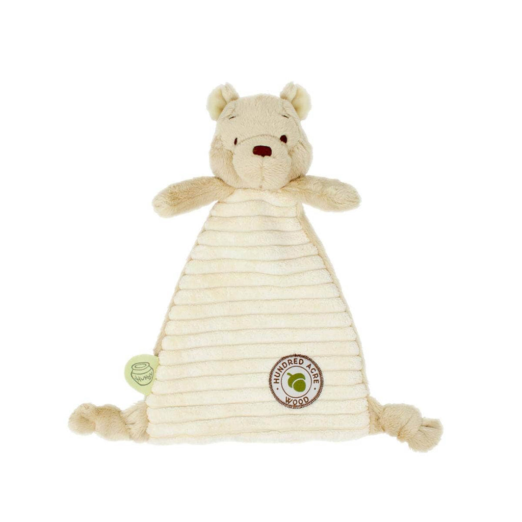 Baby holding Winnie the Pooh comforter soft toy with Hundred Acre Wood badge