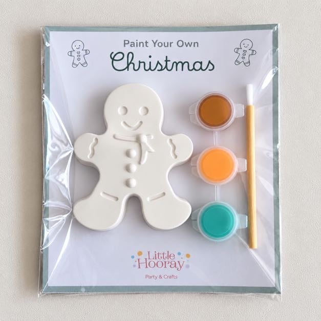 Paint Your Own Christmas craft kit with a plaster gingerbread man, three paint pots and brush in a cellophane pack
