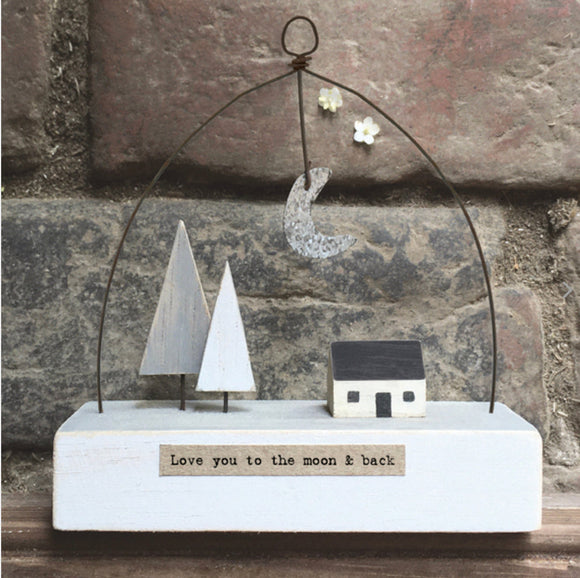 wooden house and trees with wire hanger and moon with saying love you to the moon and back